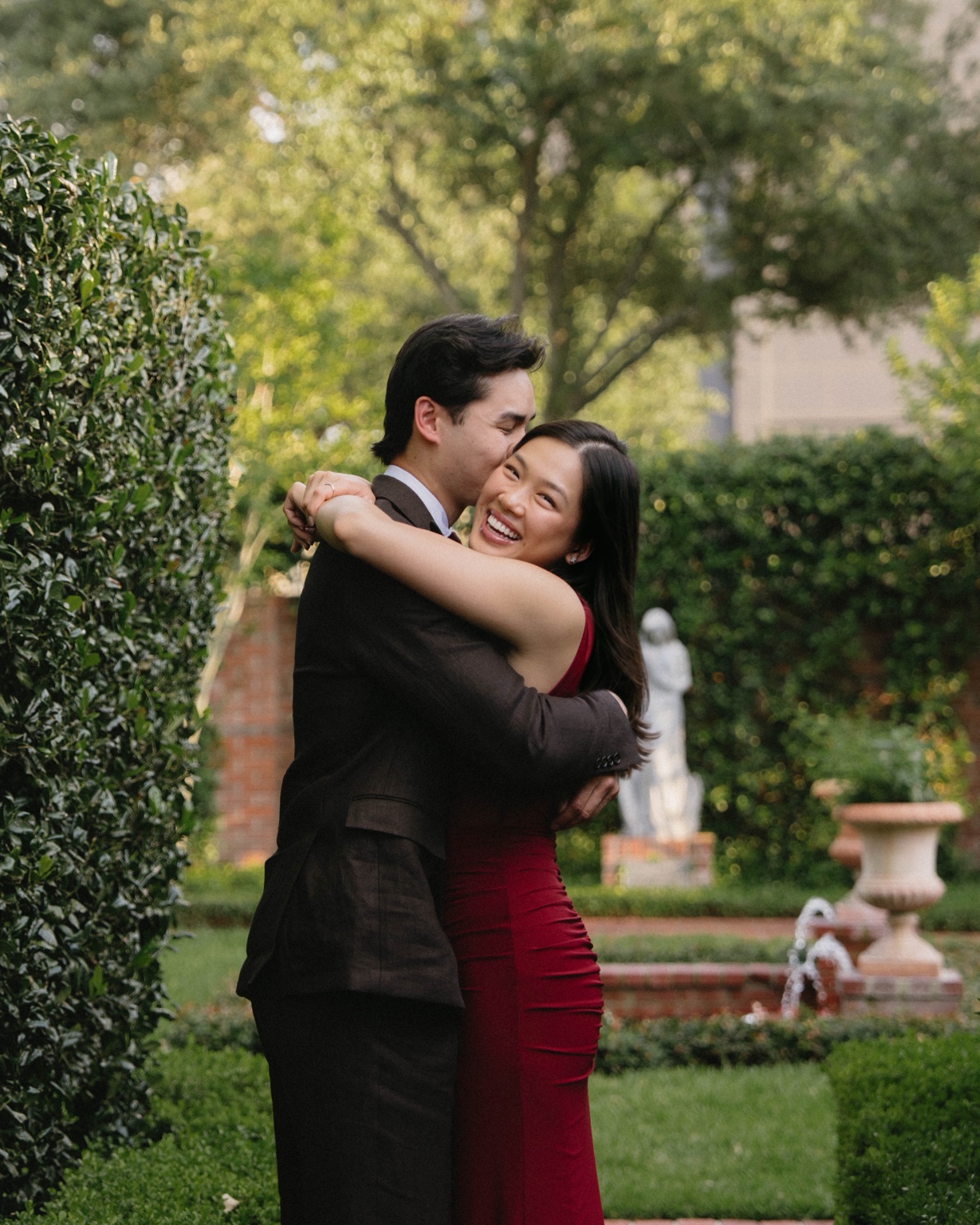 Allyson and Alex embracing in a garden